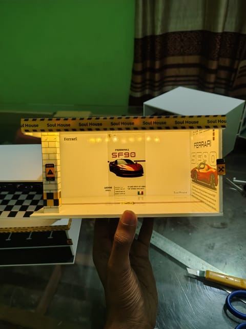 Premium handmade Ferrari SF90 themed LED diorama with luxury showroom design and battery-powered lighting. Perfect for displaying 1:64 scale diecast cars, photography setups and collectors.