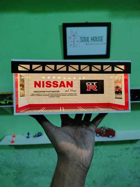Premium handmade Nissan GT-R themed LED diorama with realistic garage design and battery-powered lighting. Perfect for displaying 1:64 scale diecast cars, photography setups and collectors.